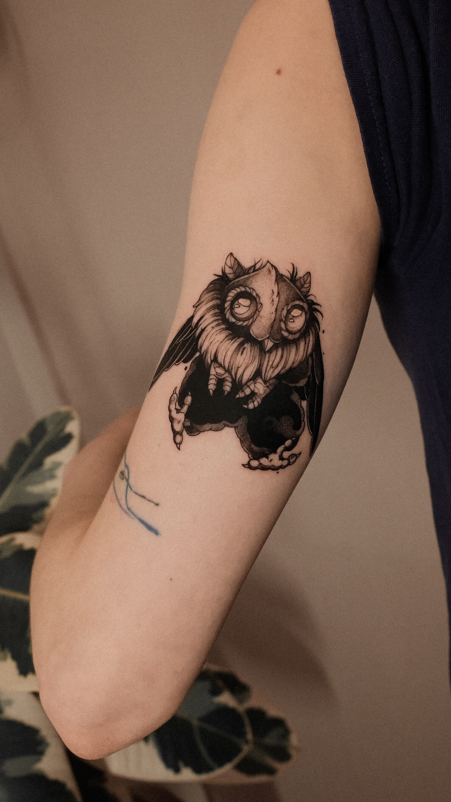 Dark graphic owl creature tattoo on inner arm — tattoo Barcelona
