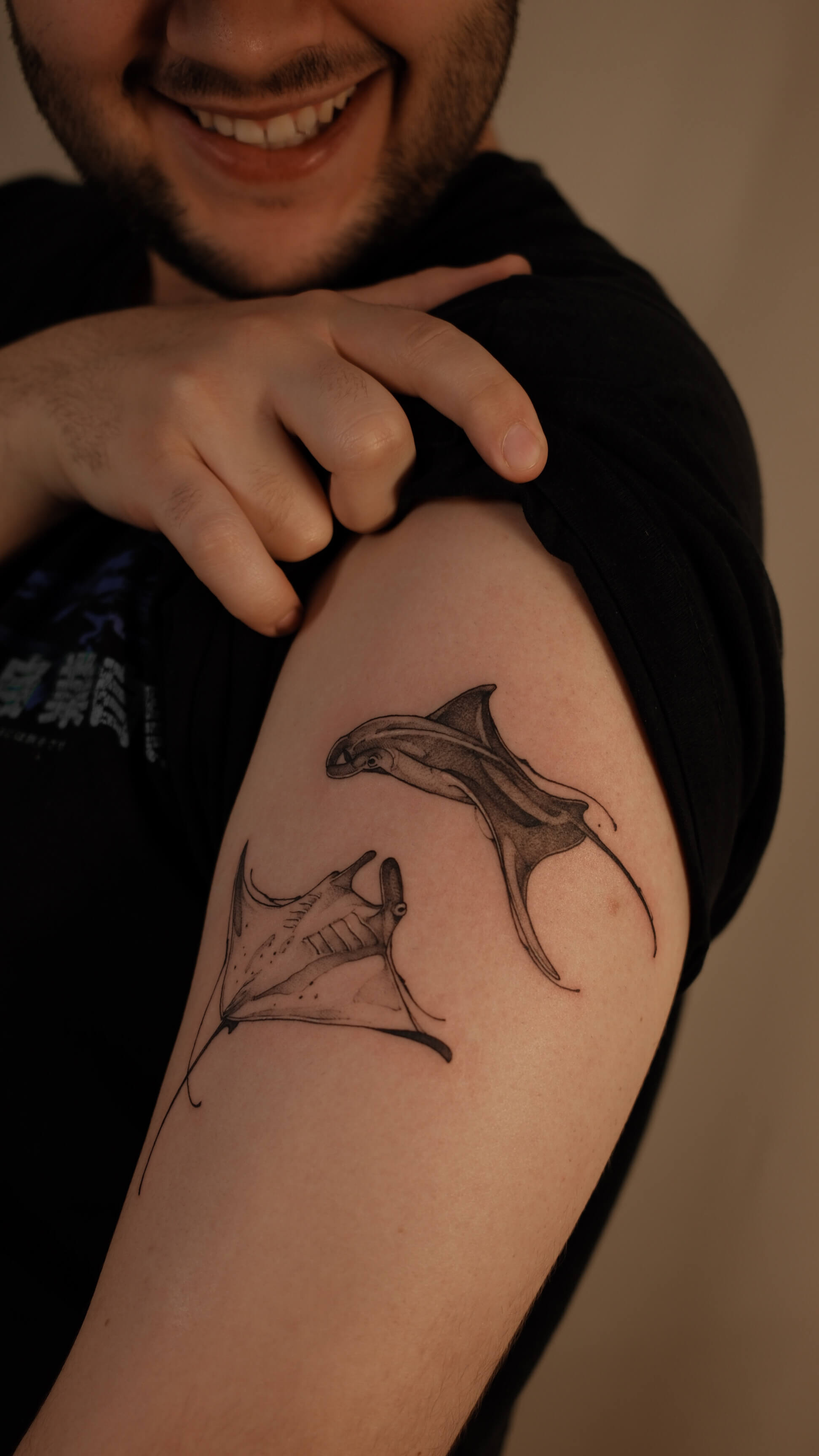 Sketch tattoo of two manta rays on upper arm — tattoo Barcelona